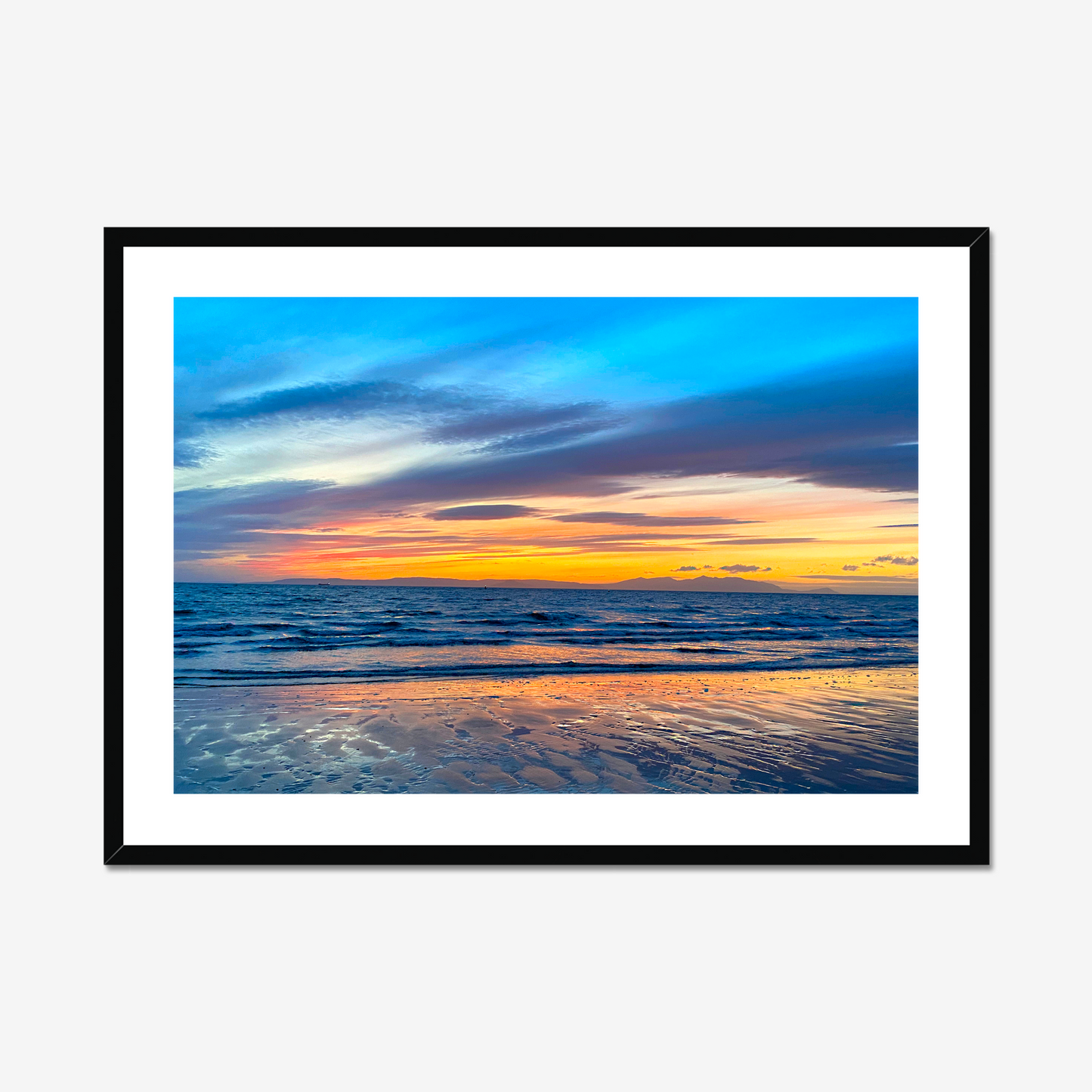 Framed artwork of a sunset over water with a black frame.
