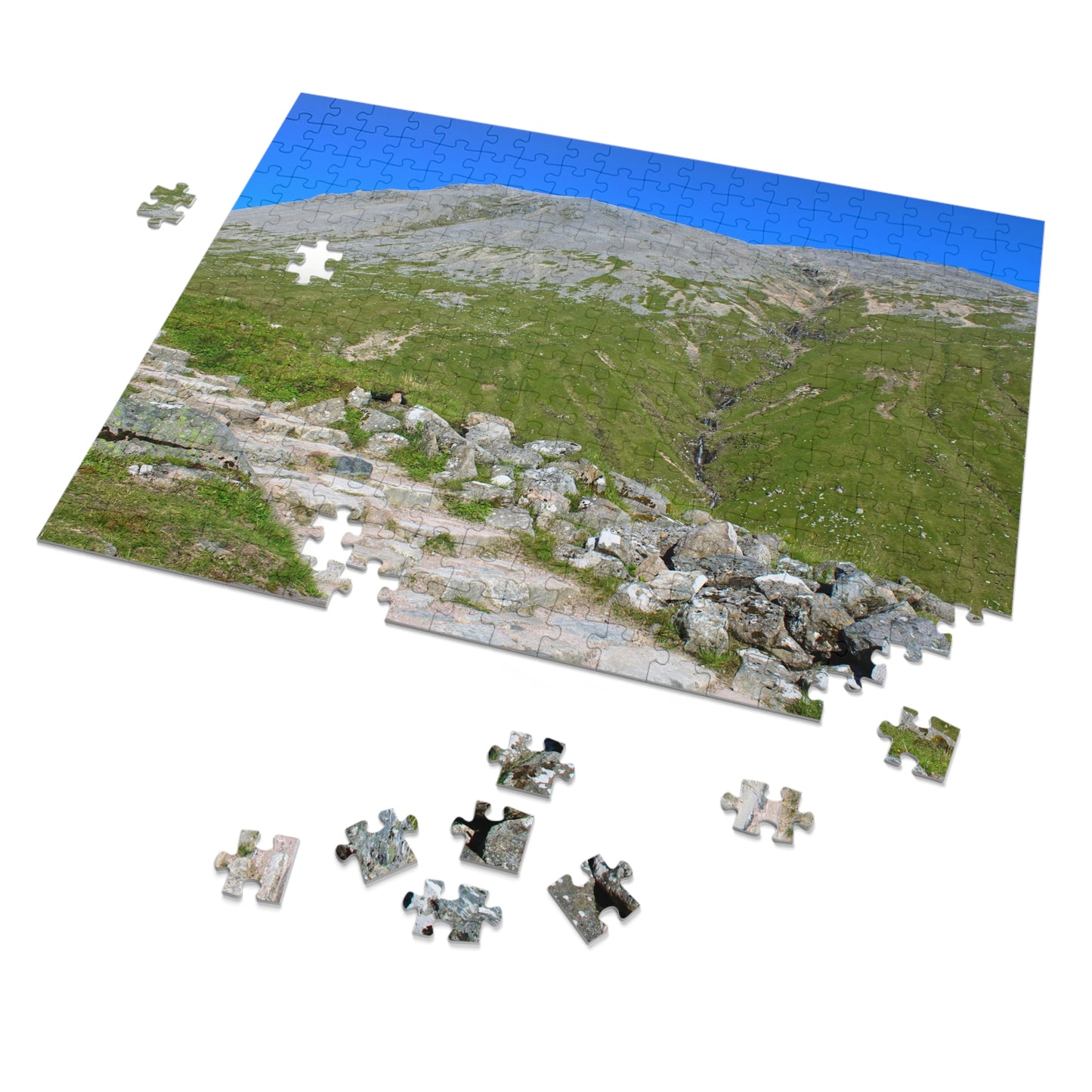 Jigsaw puzzle of a mountain landscape with completed pieces on a white background