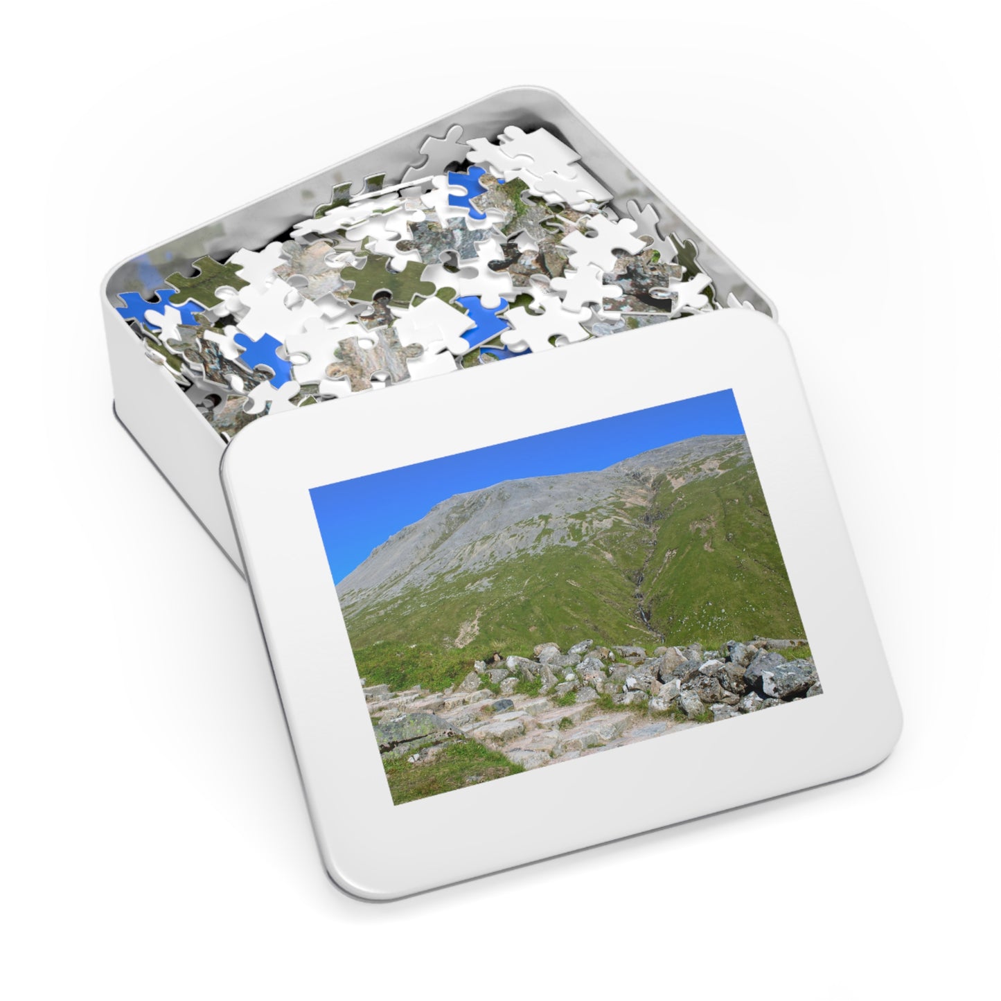 Jigsaw puzzle with a completed section showing a mountain landscape in a white box.