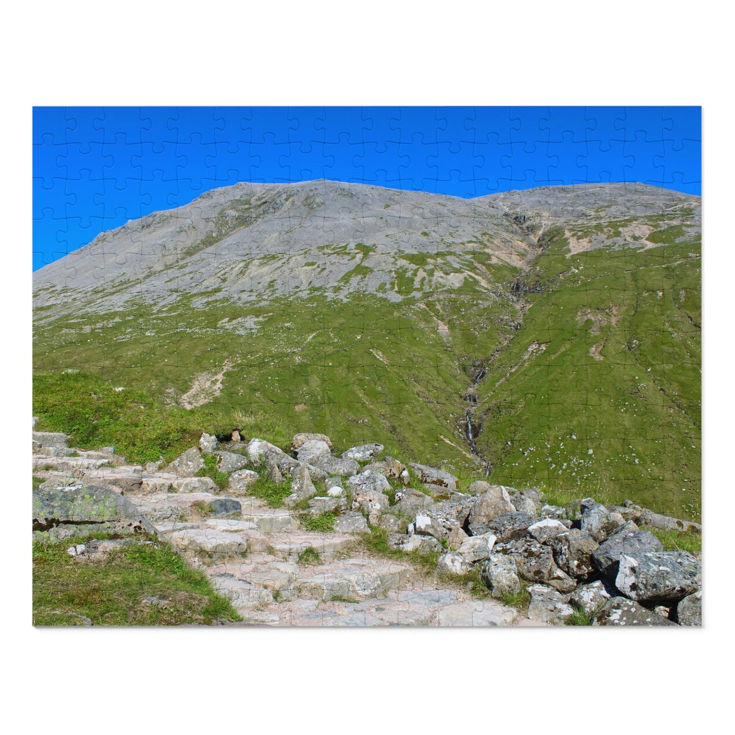 Stairway leading up a grassy hill with a clear blue sky