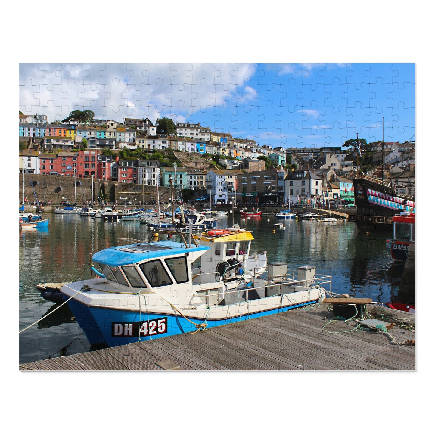 Boat docked at a harbor with colorful buildings in the background