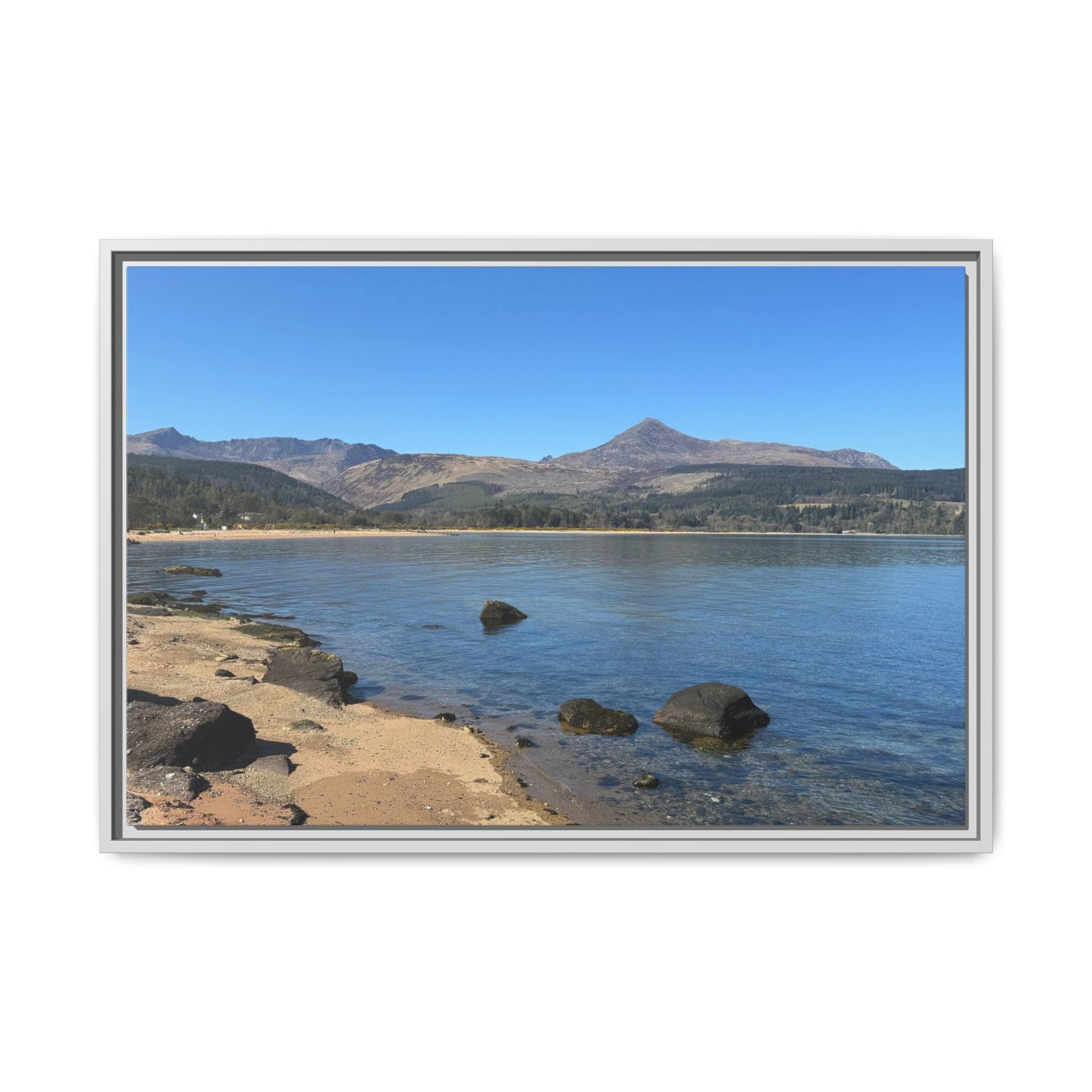 Landscape of a lake with mountains in the background, framed in silver.
