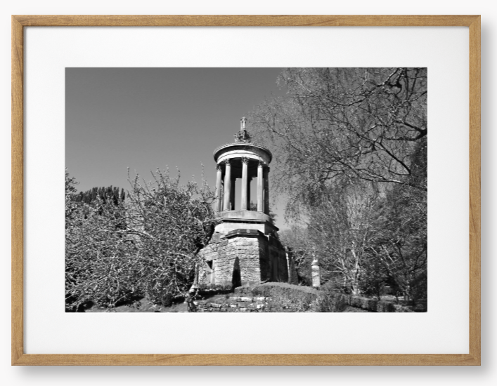 Black and White Framed Photo Of A Stone monument in a park with trees