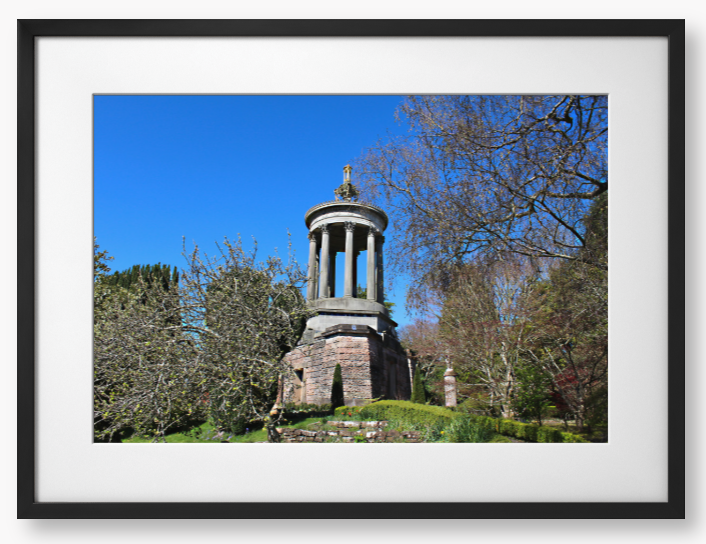 Framed Photo Of A Stone monument in a park with trees and blue sky