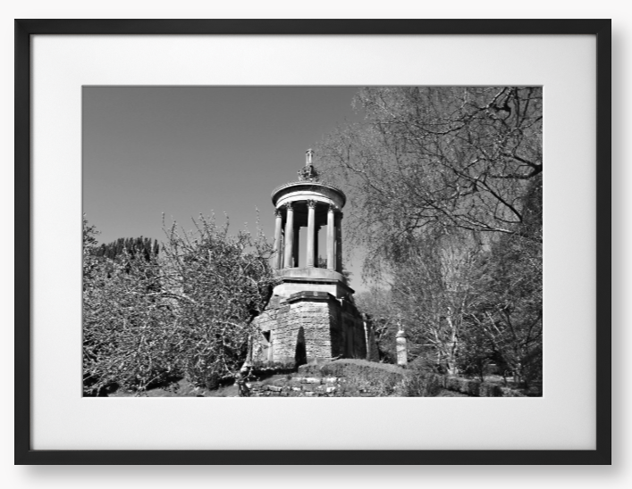 Black and White Framed Photo Of A Stone monument in a park with trees