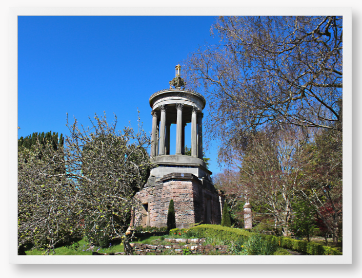 Framed Photo Of A Stone monument in a park with trees and blue sky