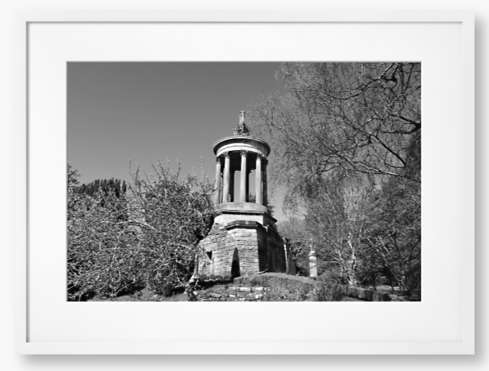 Black and White Framed Photo Of A Stone monument in a park with trees