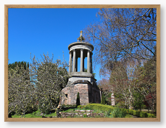 Framed Photo Of A Stone monument in a park with trees and blue sky