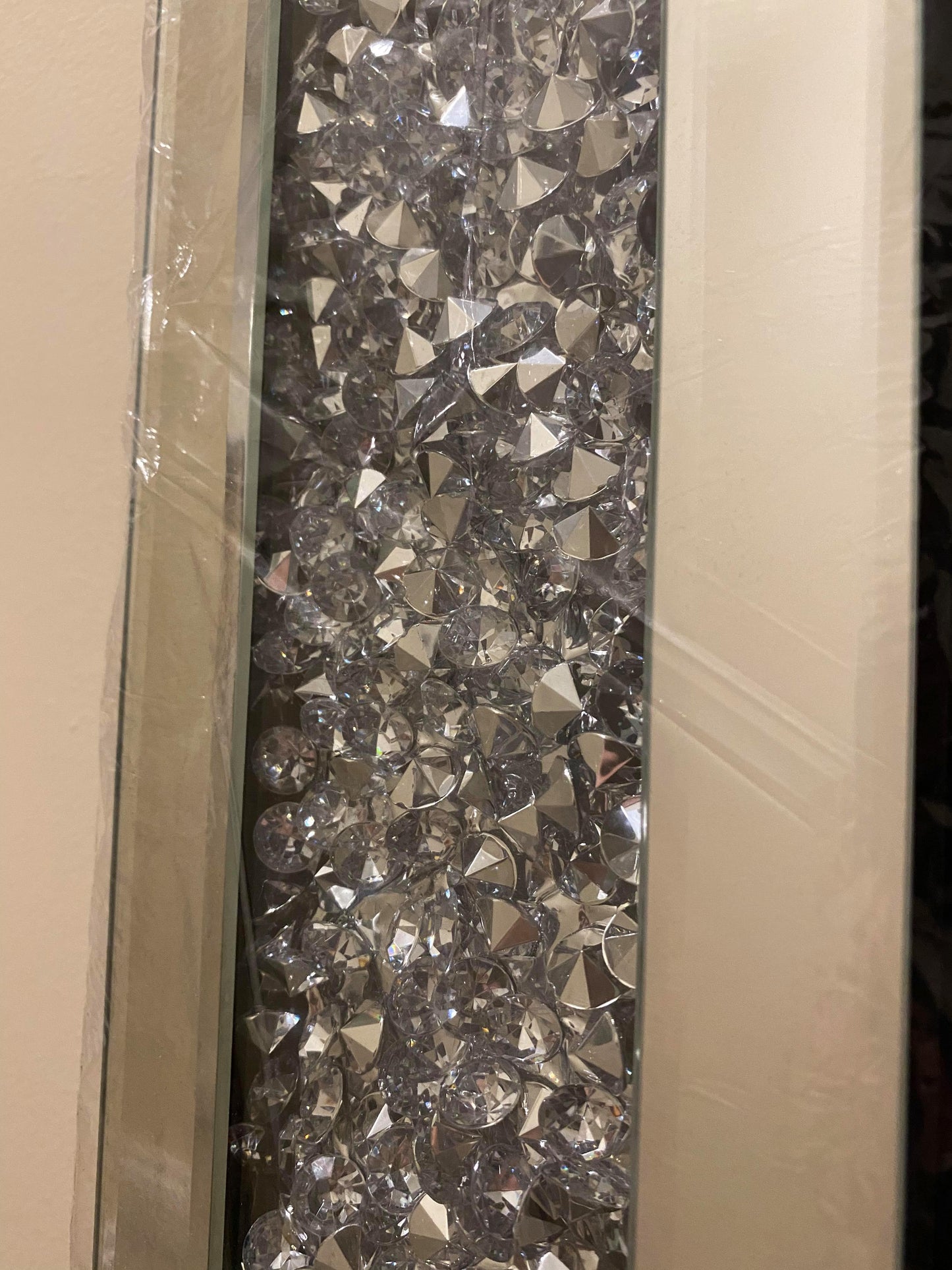 Frame of a bevelled wall mirror with crushed crystals.