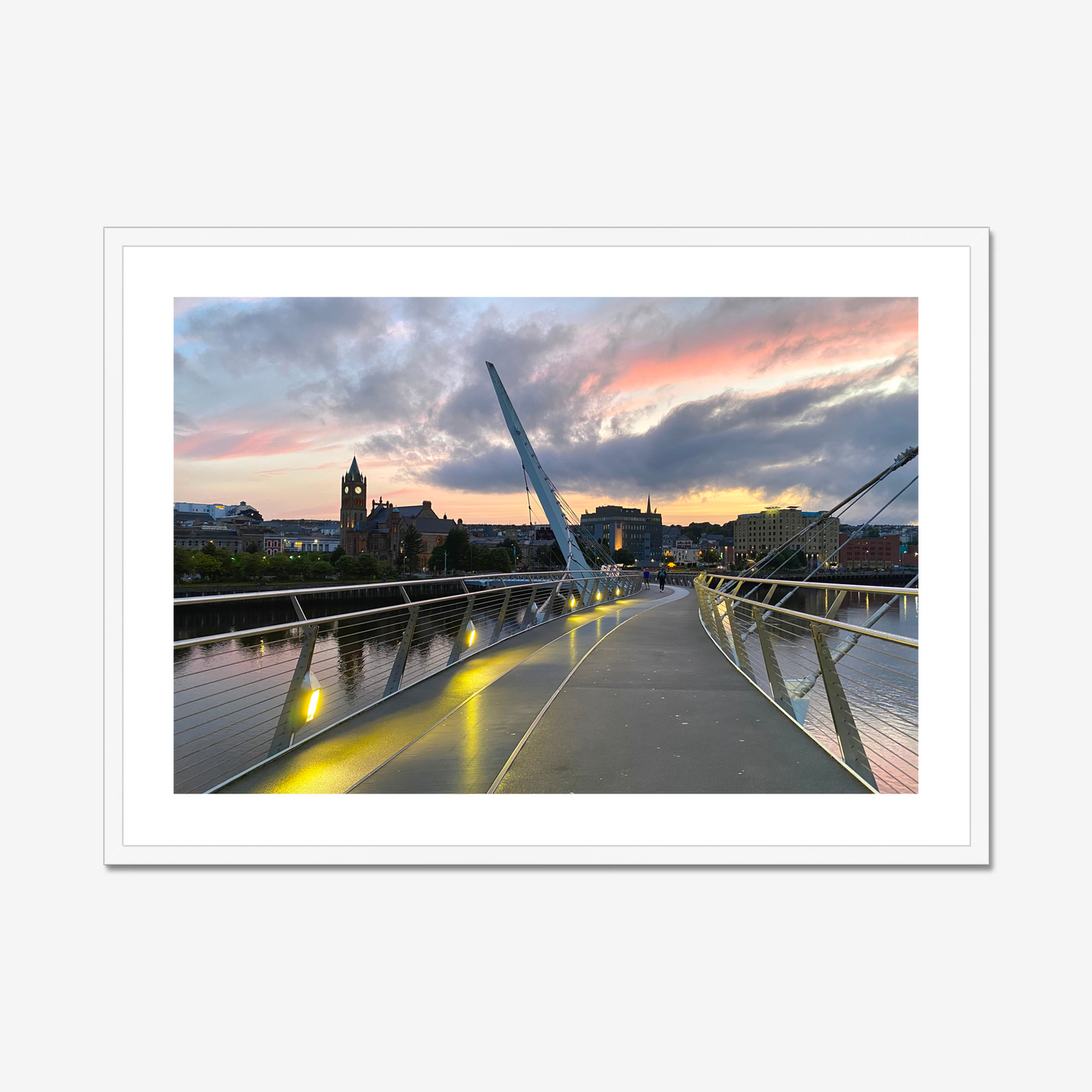 Modern bridge with a cityscape and sunset sky in the background