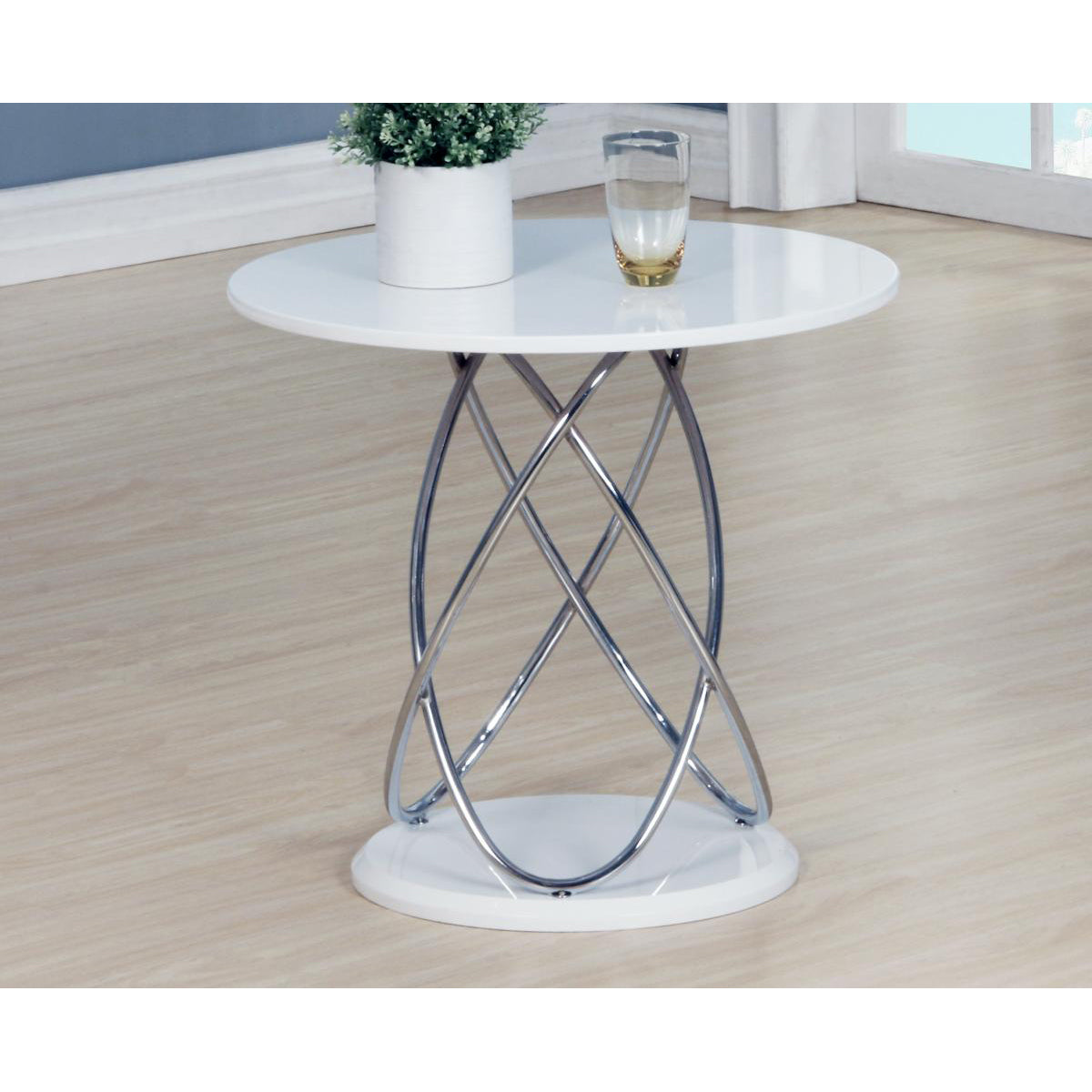 White high gloss round table with chrome base on a wooden floor