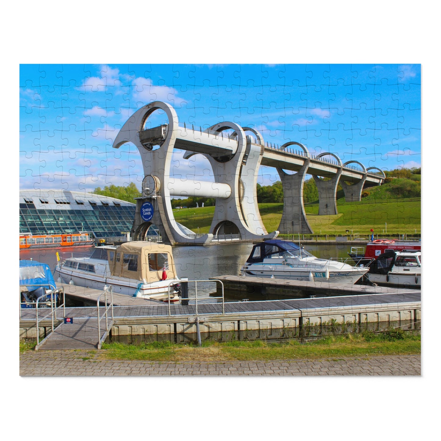 Falkirk Wheel boat lift with boats docked below on a clear day