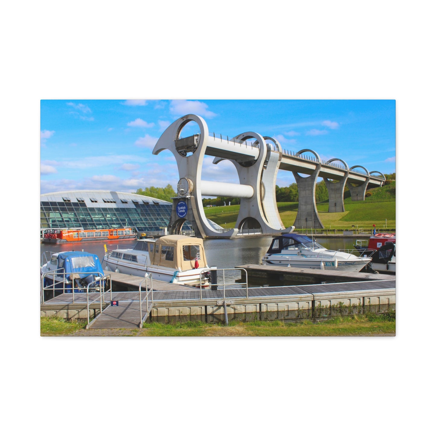 Modern architectural structure with boats docked below on a clear day