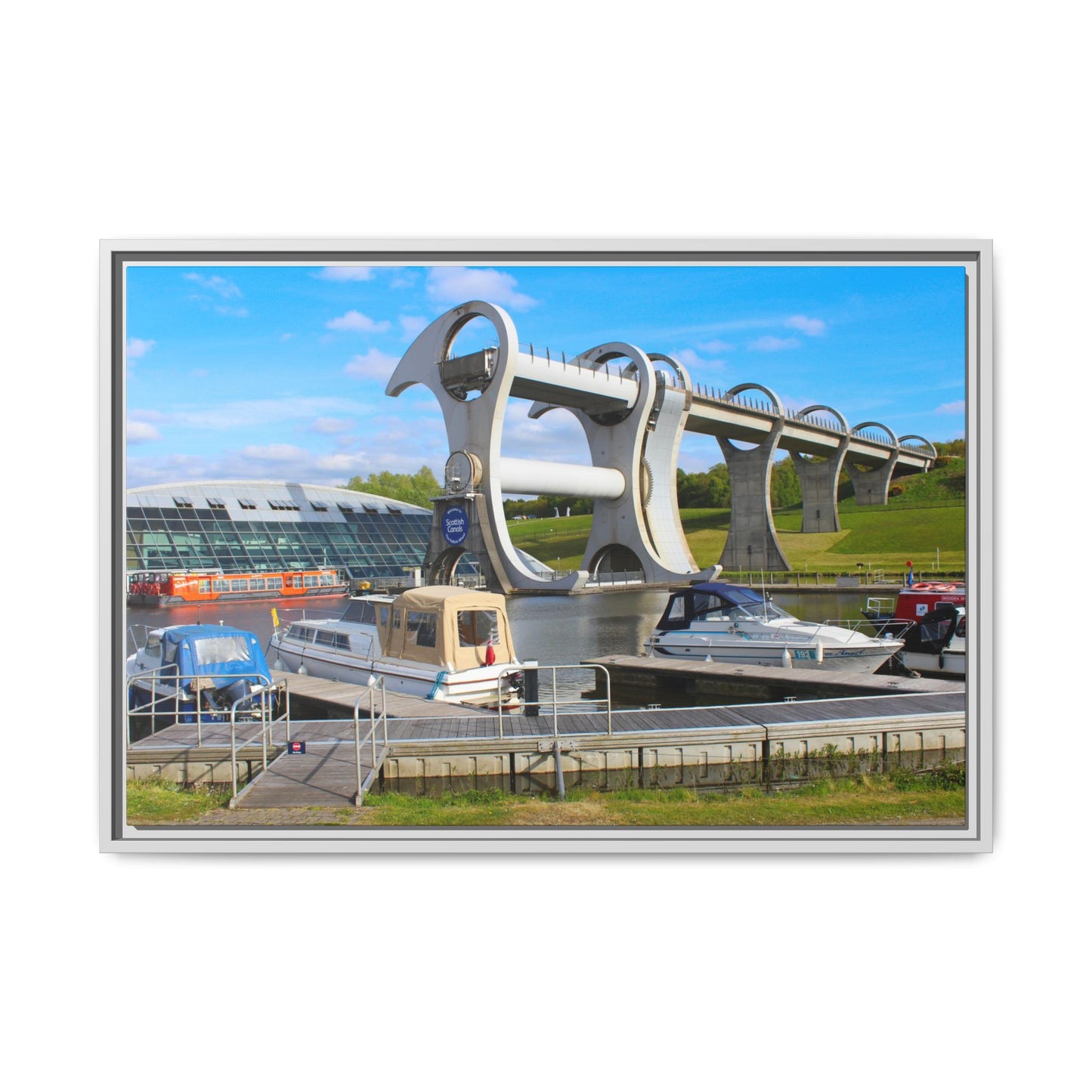 Falkirk Wheel boat lift with boats docked below on a clear day