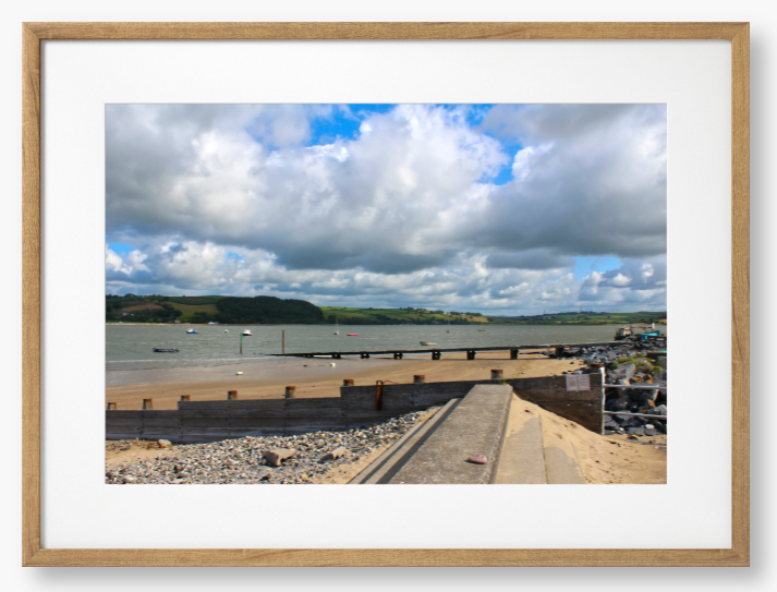 Framed Photo of a Beach scene with a large body of water, sky with clouds, and distant hills.
