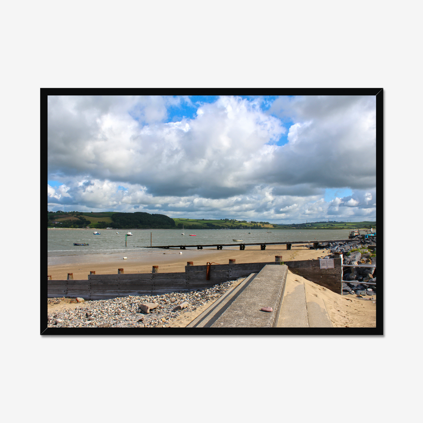 Framed photograph of a coastal scene with a dock and cloudy sky.