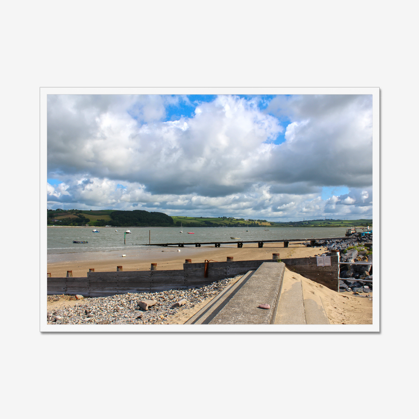 Framed photograph of a coastal scene with a dock and cloudy sky.