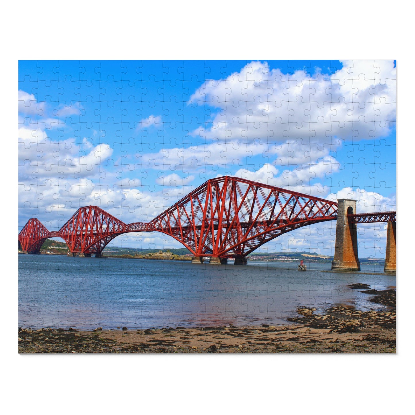 Red bridge over water with a blue sky and clouds