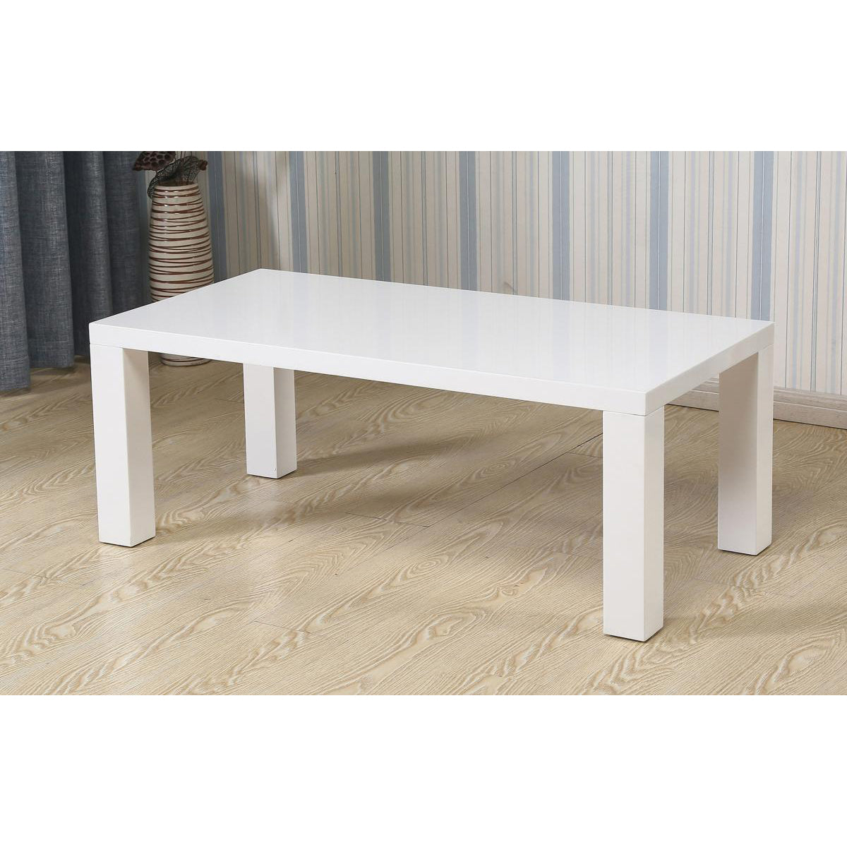 White high gloss coffee table on a wooden floor with striped wallpaper in the background