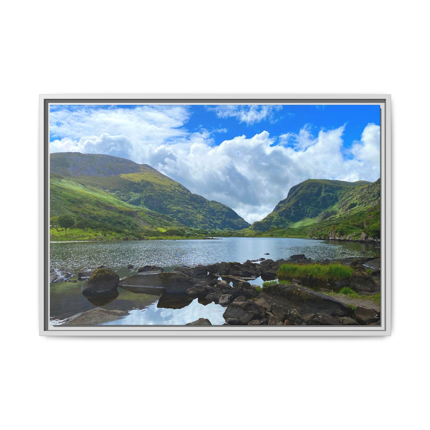 Framed photograph of a scenic landscape with a lake and mountains.