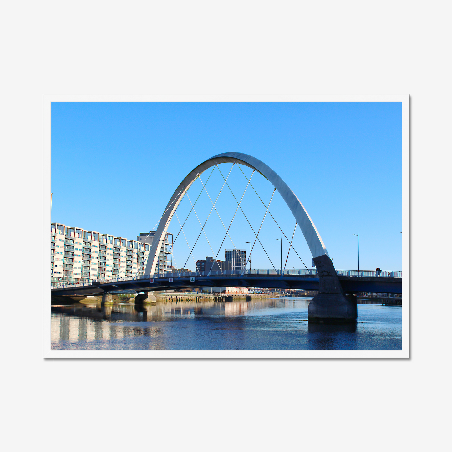 Framed photograph of a cityscape with a bridge over water.