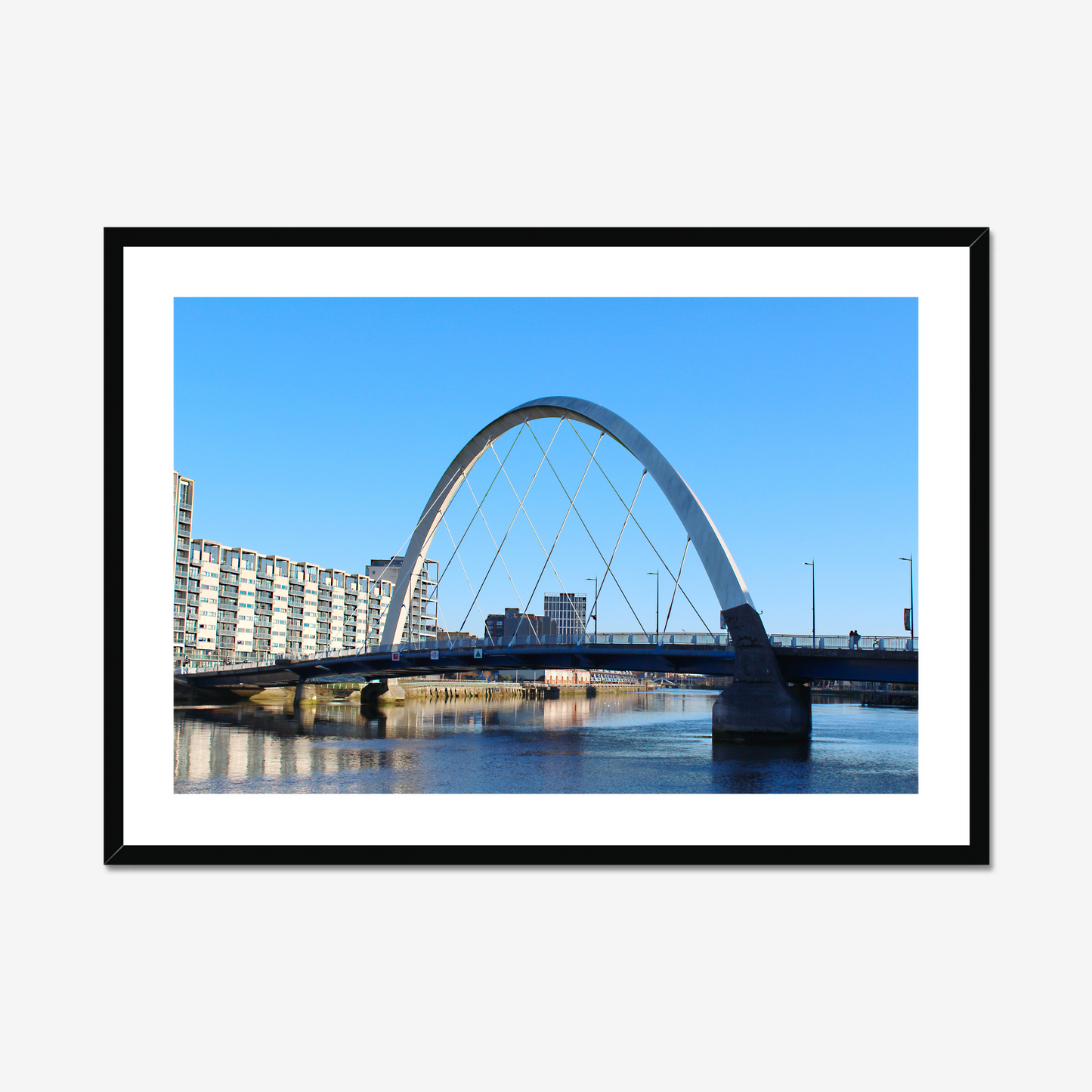 Framed photograph of a cityscape with a bridge over water.