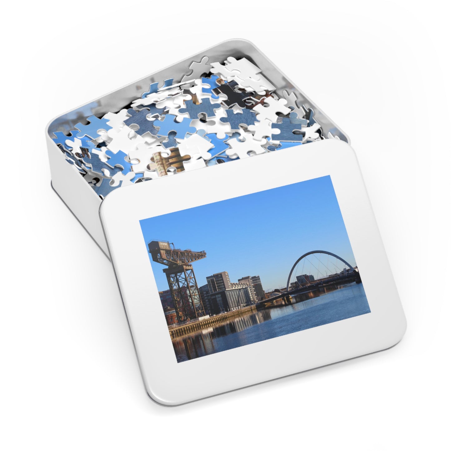 Jigsaw puzzle in a tin with a scenic picture on the lid