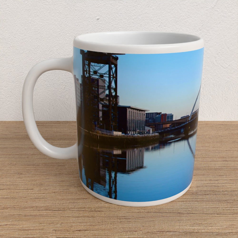Mug with a scenic design of a crane and buildings on a reflective surface