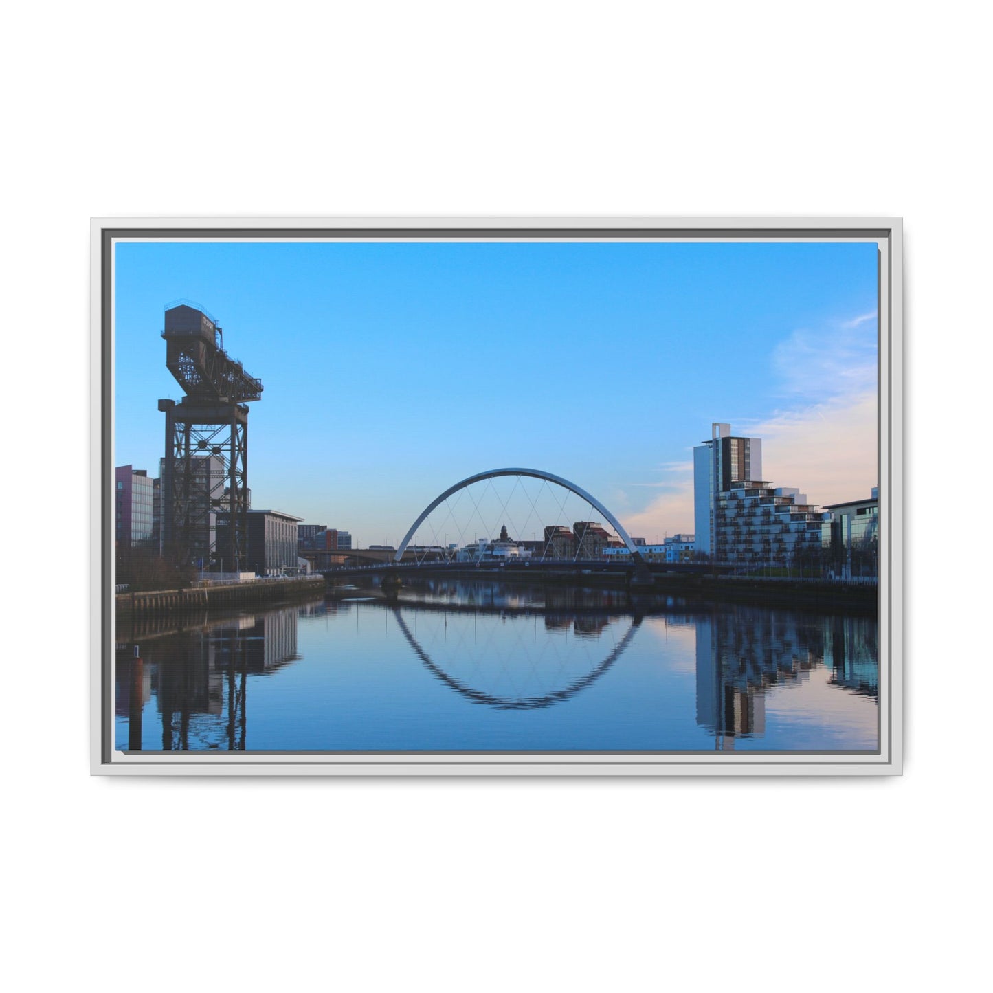 Cityscape with a crane and arch reflected in water, framed as a photograph.