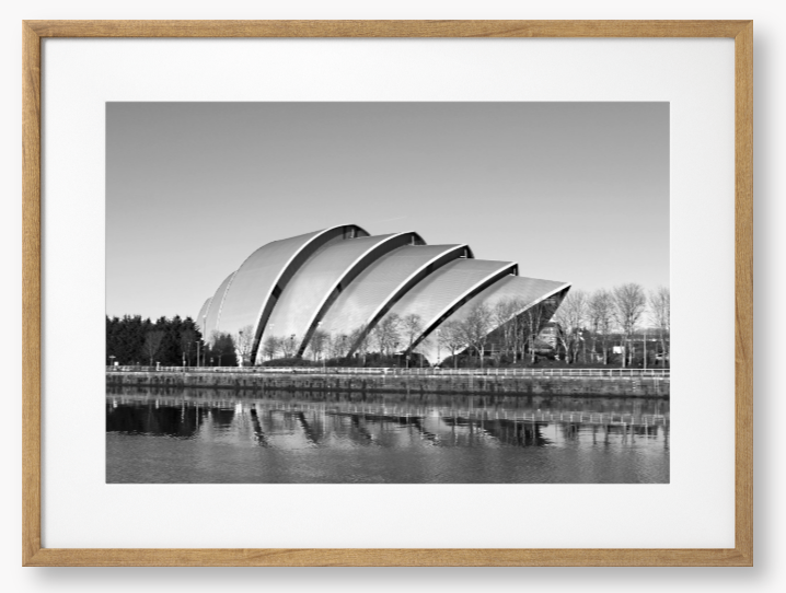 Black and white framed photo of a modern architectural structure reflected in water