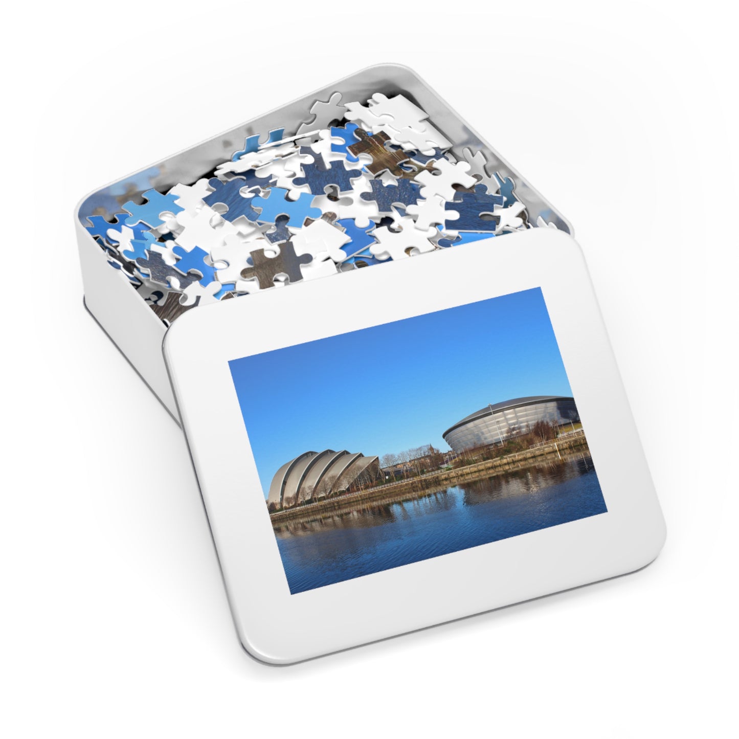 Jigsaw puzzle in a tin with a scenic picture on the lid