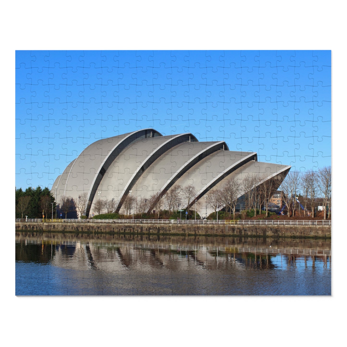 Modern architectural building with a reflective water surface and blue sky