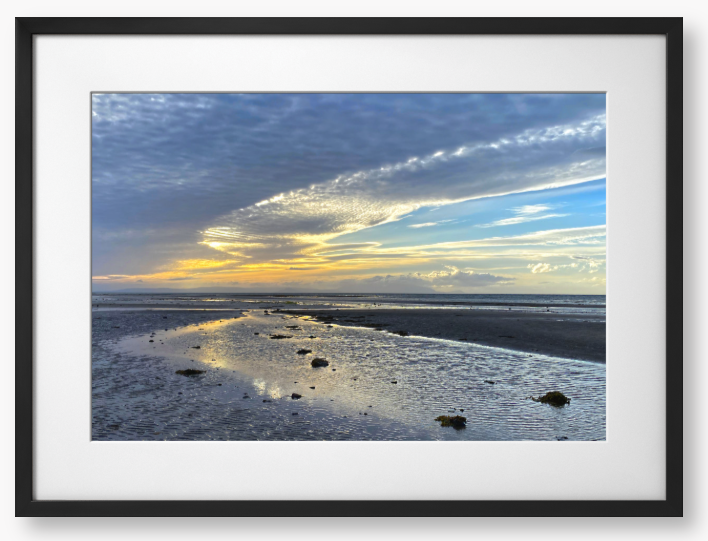 Framed Photo Of A Sunset over a beach with clouds and water reflections