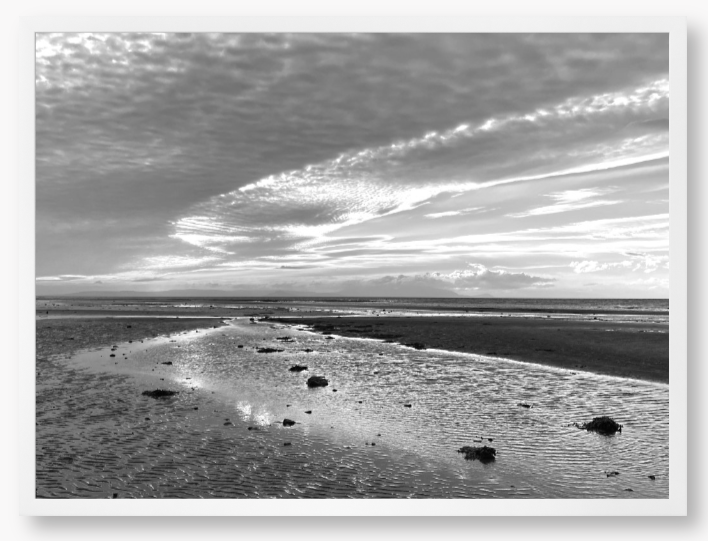 Framed Black and White Photo of a coastal landscape with a cloudy sky