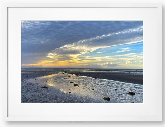 Framed Photo Of A Sunset over a beach with clouds and water reflections