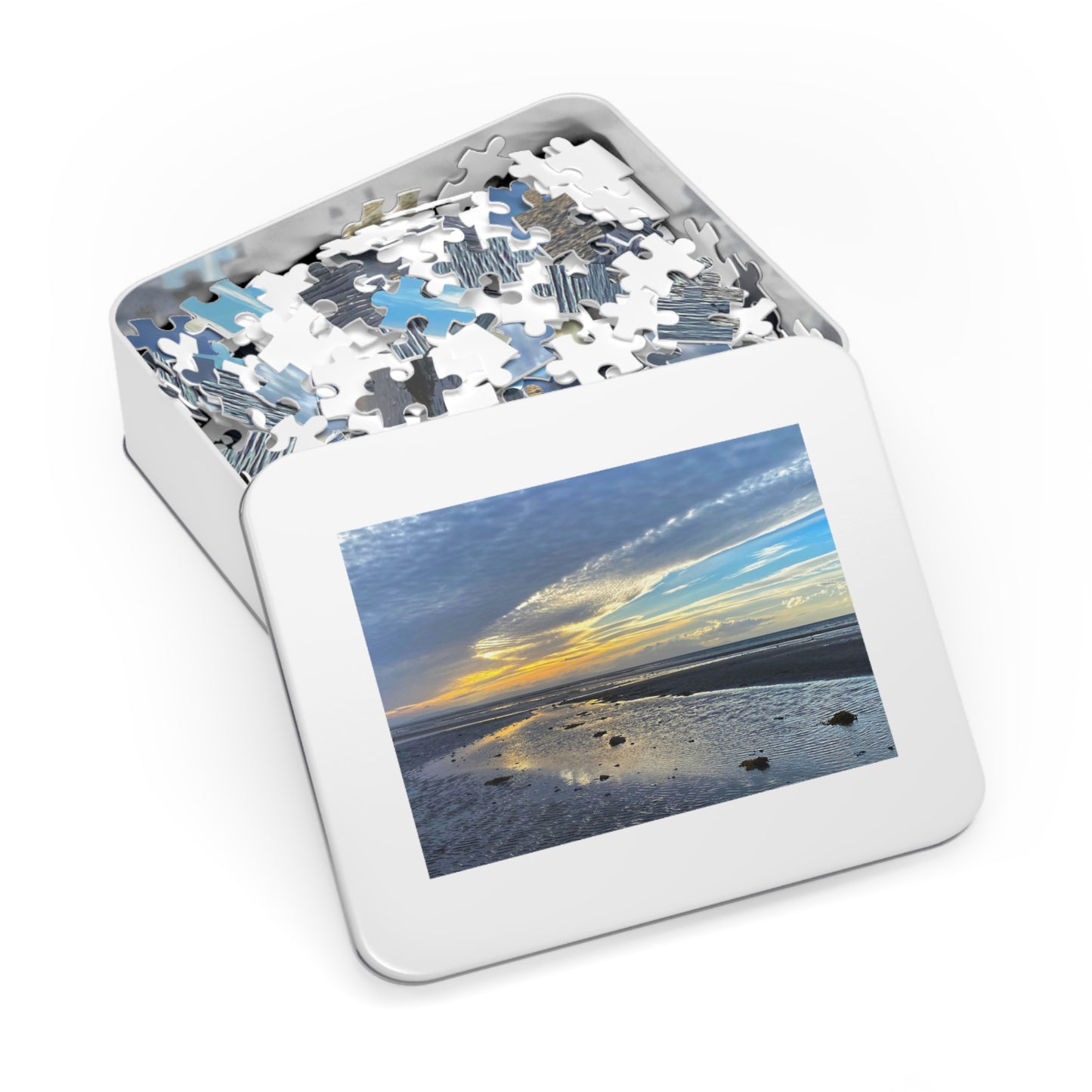 Jigsaw puzzle in a tin with a beach scene on the cover