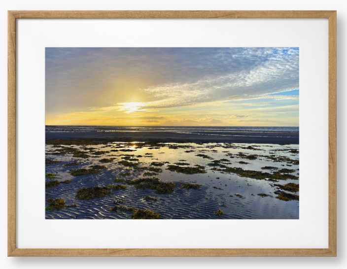 Framed Photo Of A Sunset over a coastal landscape with wet sand and low tide.