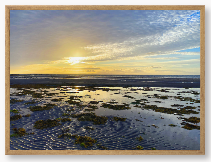Framed Photo Of A Sunset over a coastal landscape with wet sand and low tide.