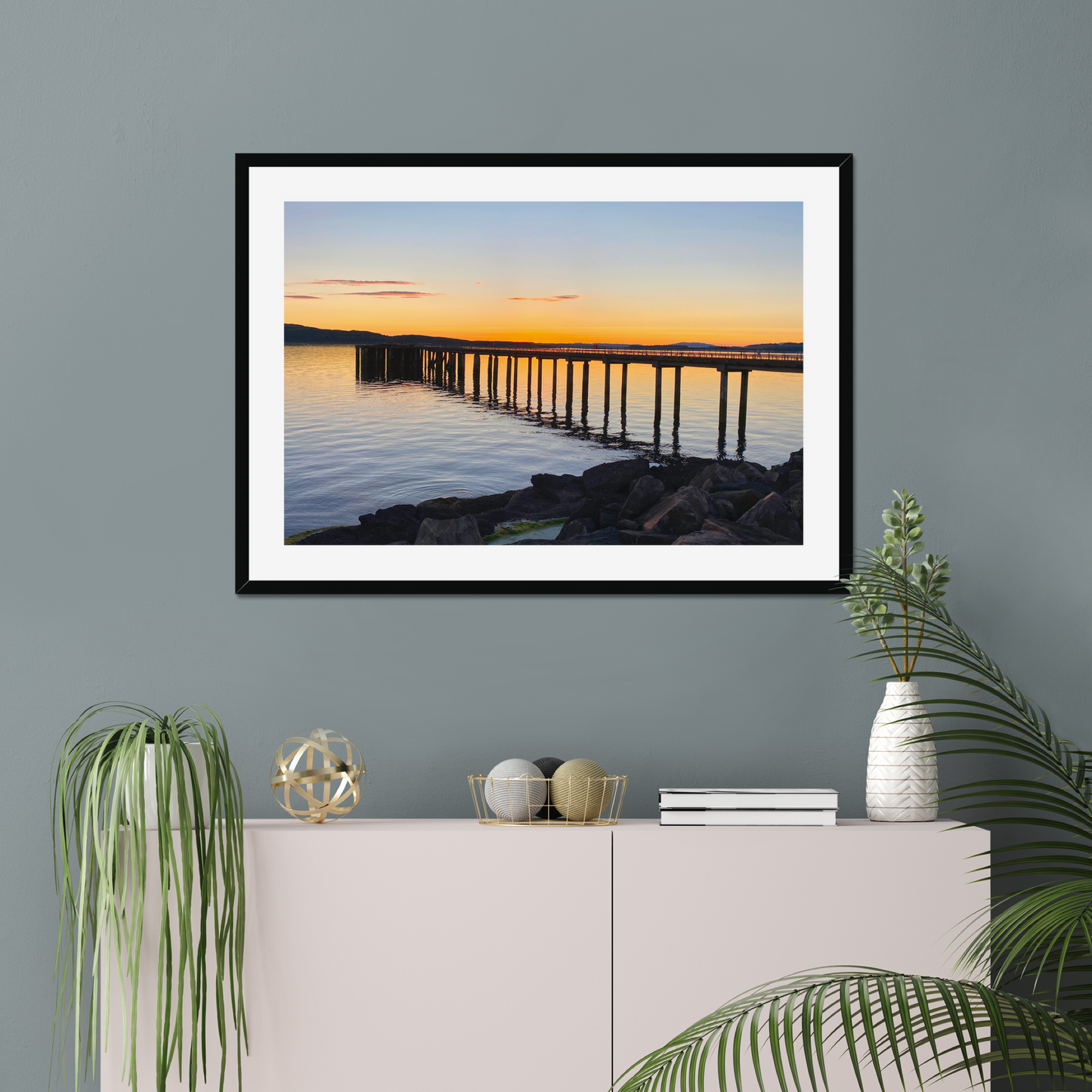 Framed photograph of a cityscape with a modern bridge at sunset.