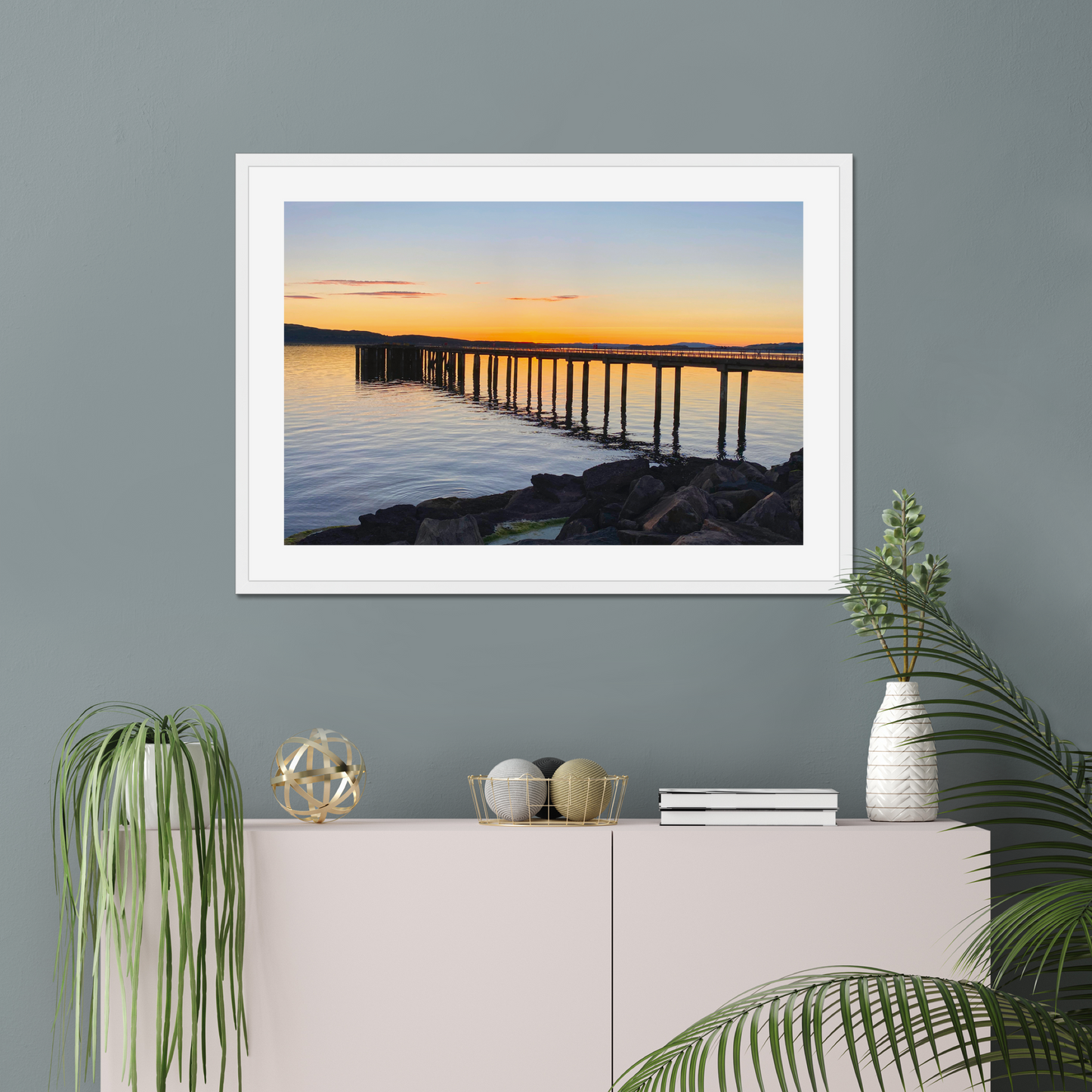 Modern bridge with a cityscape and sunset sky in the background