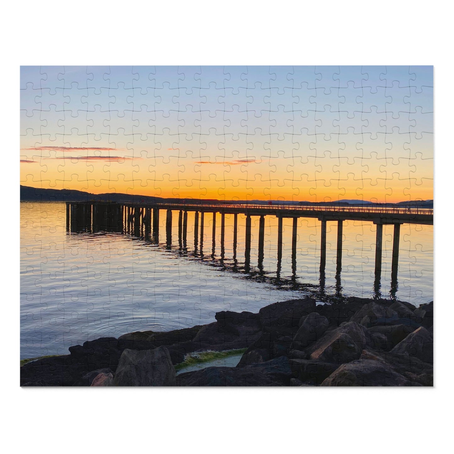 Jigsaw puzzle with a sunset over a bridge scene