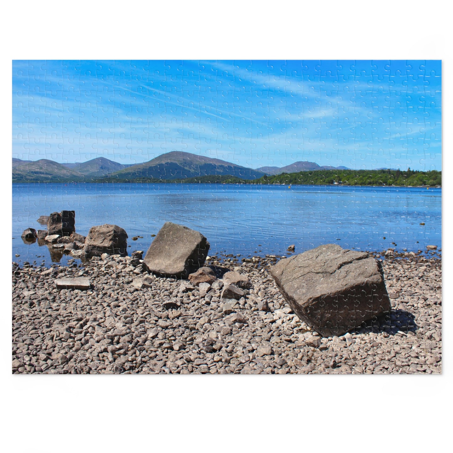 Jigsaw puzzle with a scenic view of a lake and mountains on a white background