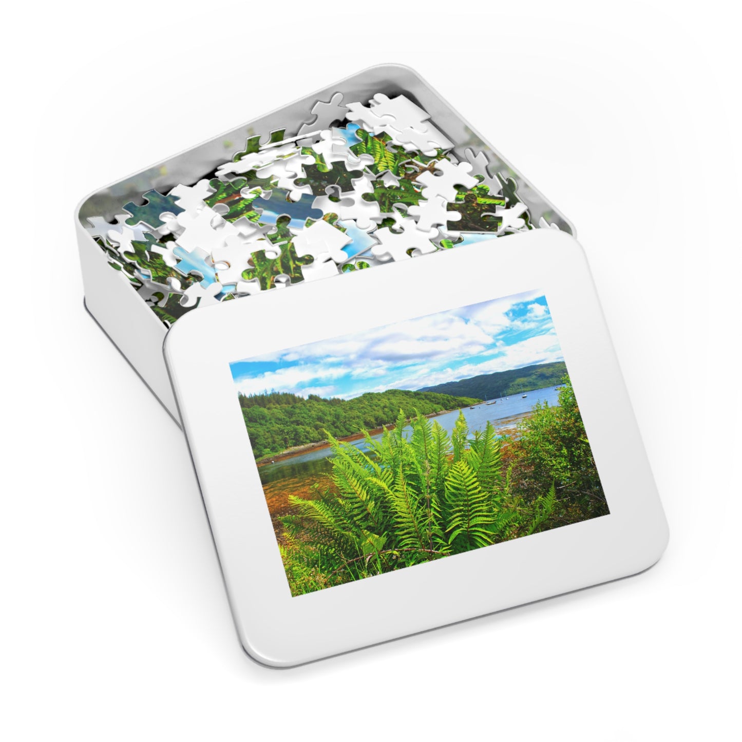 Jigsaw puzzle in a tin with a scenic view of a lake and forest on the cover