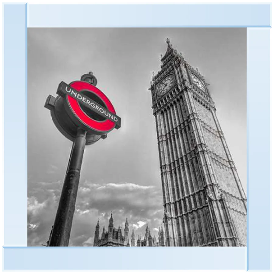 A silver mirror framed picture featuring the London Big Ben clock tower and an underground sign.