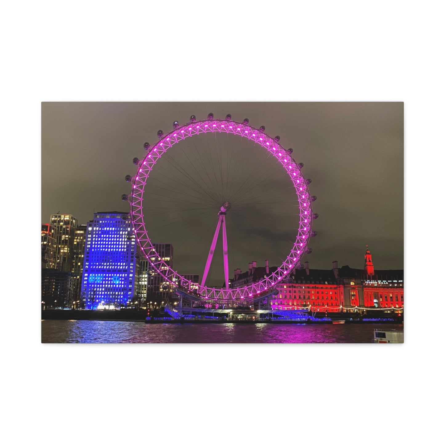Ferris wheel lit up in pink with city skyline in the background
