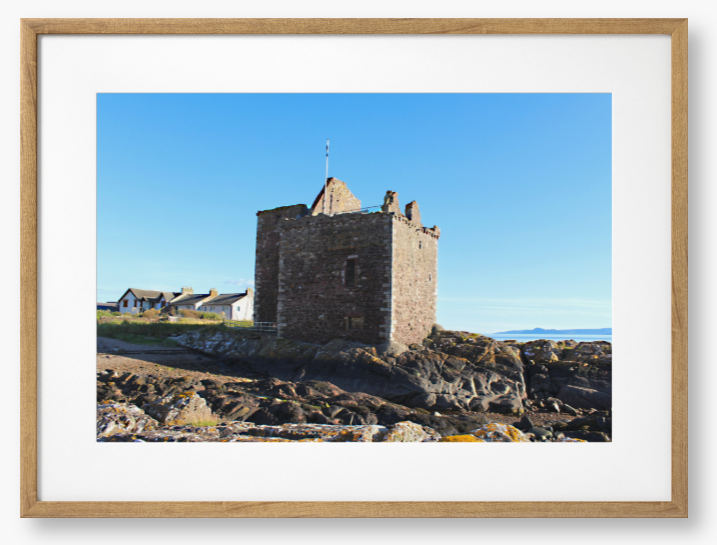 Framed Photo of a Stone castle on rocky terrain with a clear blue sky