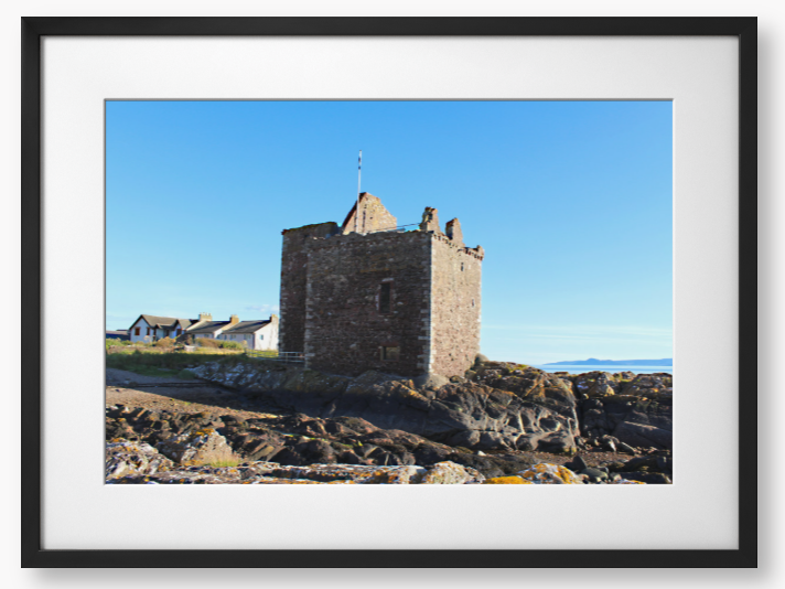 Framed Photo of a Stone castle on rocky terrain with a clear blue sky