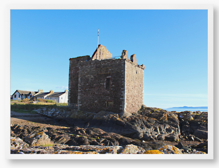 Framed Photo of a Stone castle on rocky terrain with a clear blue sky
