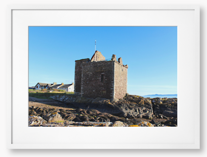 Framed Photo of a Stone castle on rocky terrain with a clear blue sky