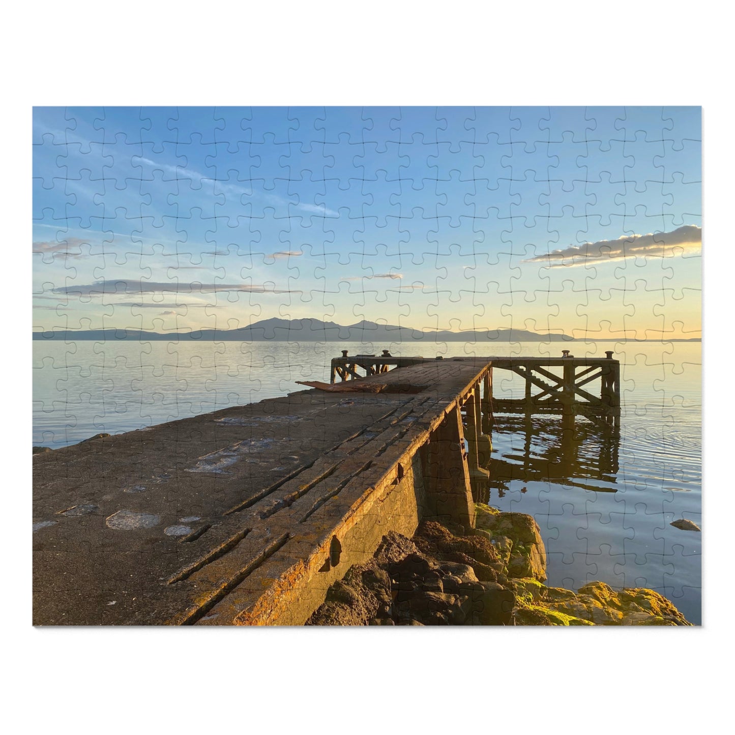 Jigsaw puzzle with a scenic view of a dock and water, featuring a wooden pier extending into the water with mountains in the background.